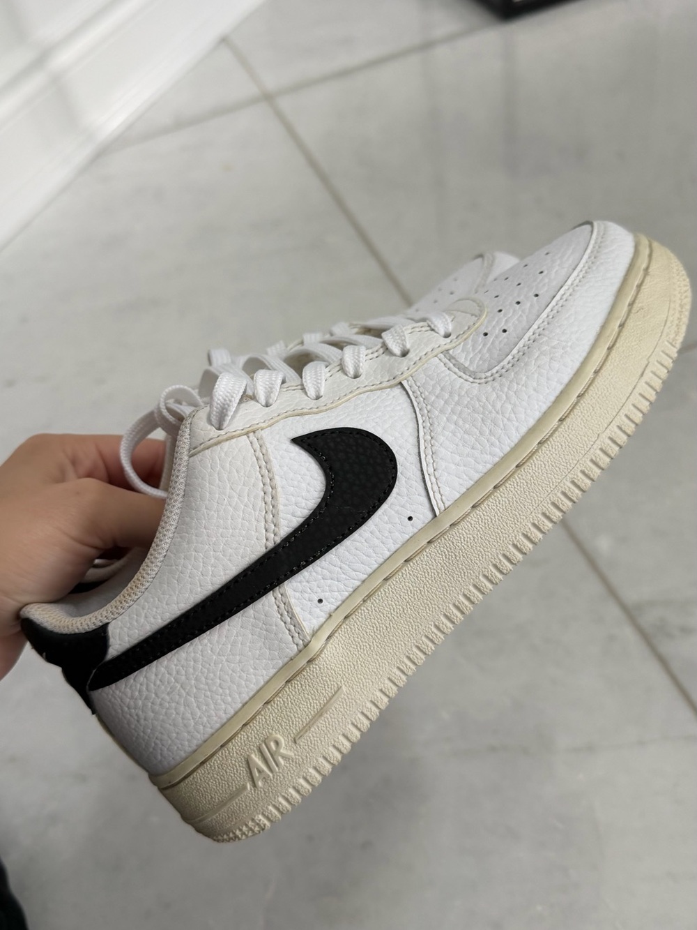 Nike women’s White Leather Low-Top Sneaker with Black Swoosh